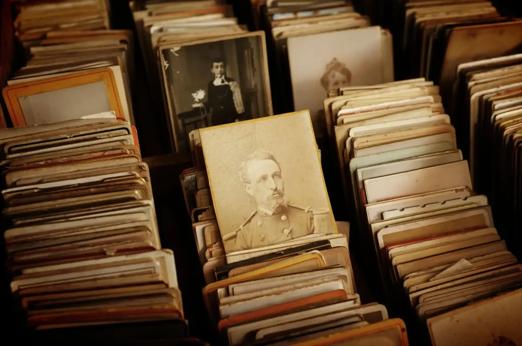 A collection of vintage photographs and postcards neatly arranged in rows.