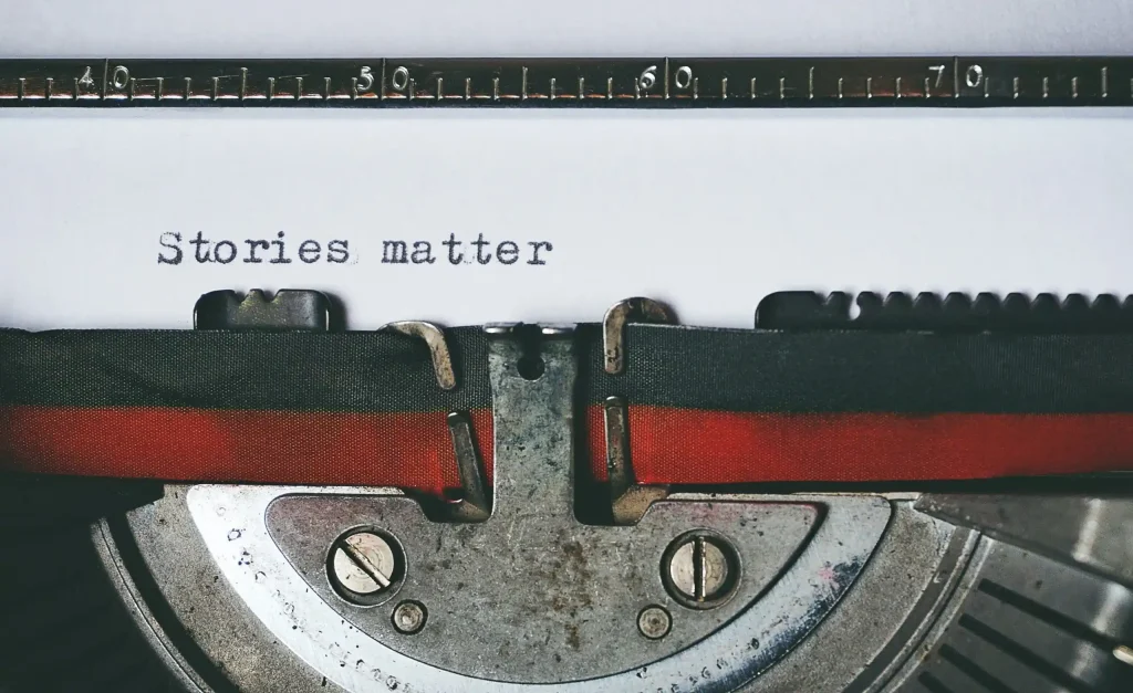 A close-up view of a vintage typewriter with the words "Stories matter" typed on paper.